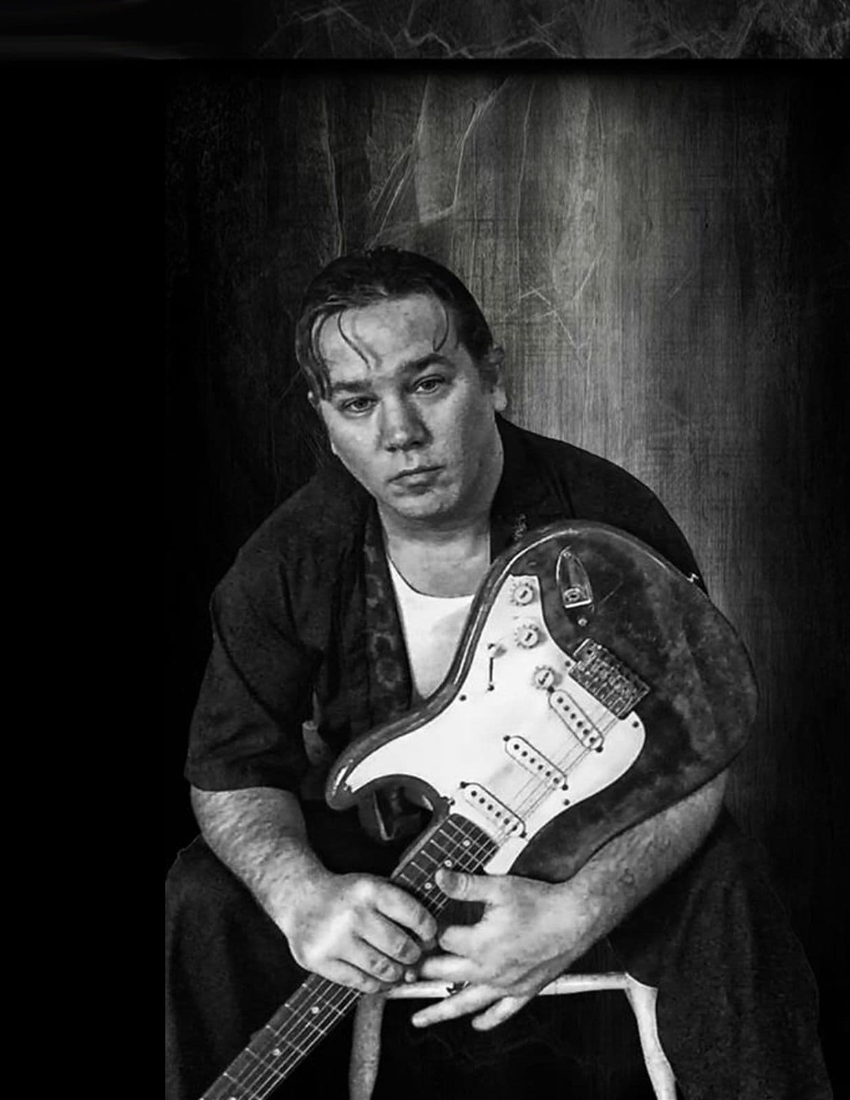 Gordon James with guitar, press portrait